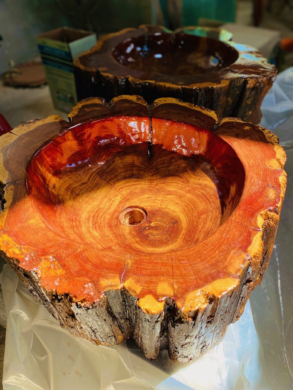 Hand-carved sink basin made from a resin-finished slab of reclaimed cedar.